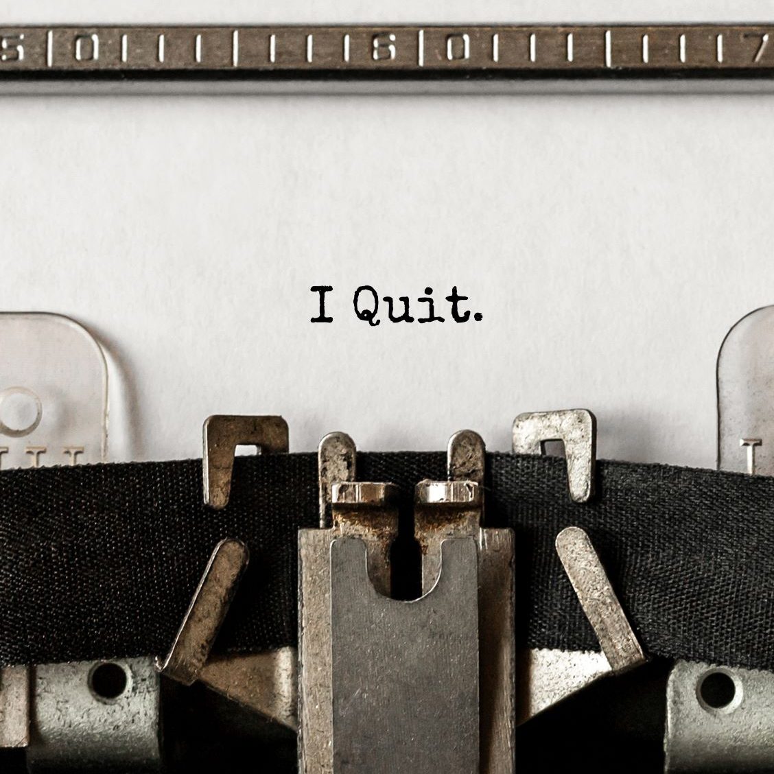 Close up shot of paper on a typewritter with the words "I quit."